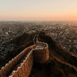 “Aerial view of Jaipur fort wall and cityscape at sunset”